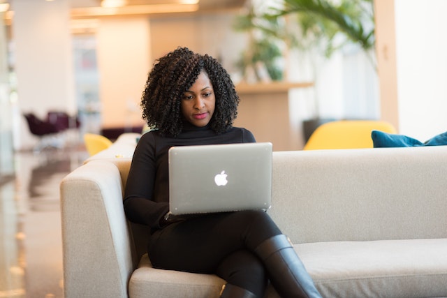 a person on a sofa using a laptop